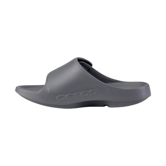 Gray foam slide sandal with embossed Oofos logo on the side
