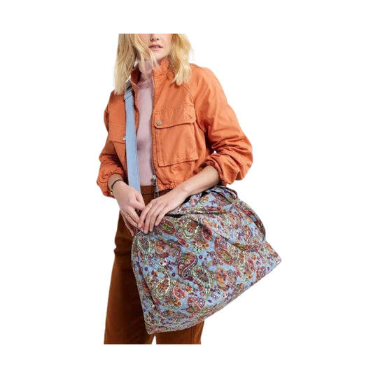 Large paisley overnight tote with light blue trim and a slouchy soft-sided shape