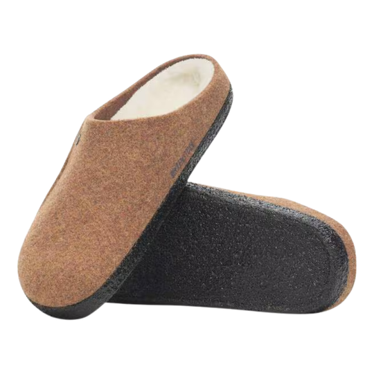Brown slipper with black sole on a white background