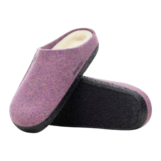 Pair of purple slippers with a white interior on a white background