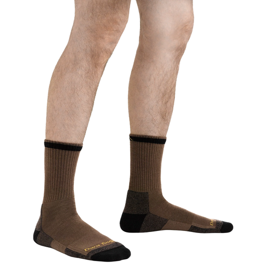 Brown socks with black accents worn by a person on a white background