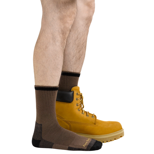 Yellow boot with a sock on a white background