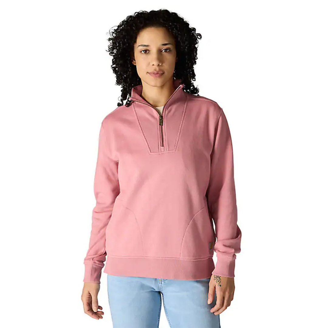 Woman wearing a pink pullover with a quarter zip on a white background