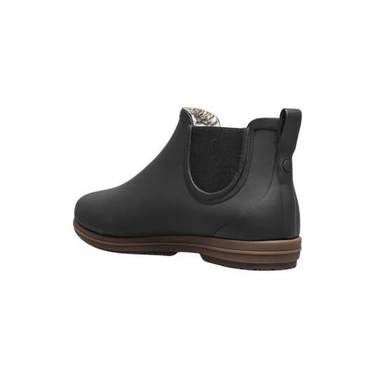 Black rubber boot with brown sole on a white background