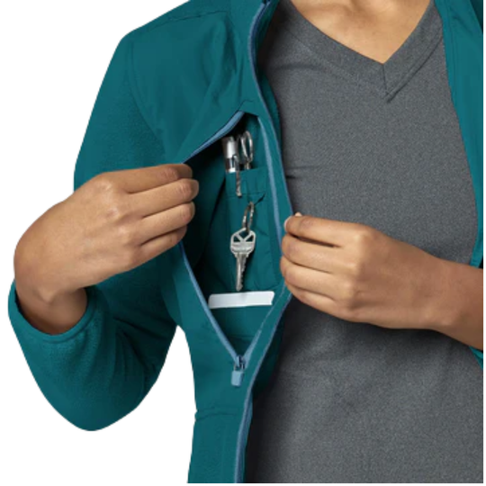 Person opening a teal jacket pocket with keys and an ID card inside.