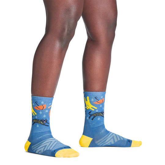 Blue socks with colorful designs worn by a person on a white background