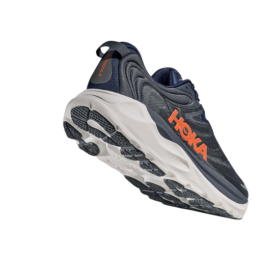 Dark navy running shoe with a white sole and orange side logo, shown from below at an angle