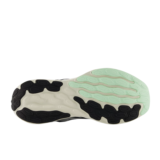 Close-up of a shoe sole with a green and black design on a white background