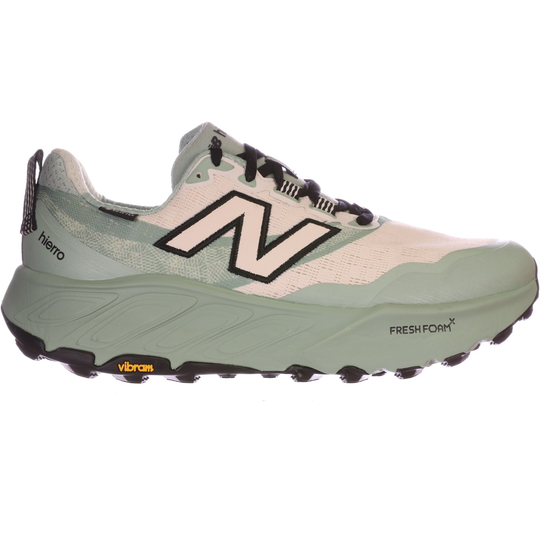 Light green and white trail running shoe with black laces, large side logo, and rugged Vibram sole