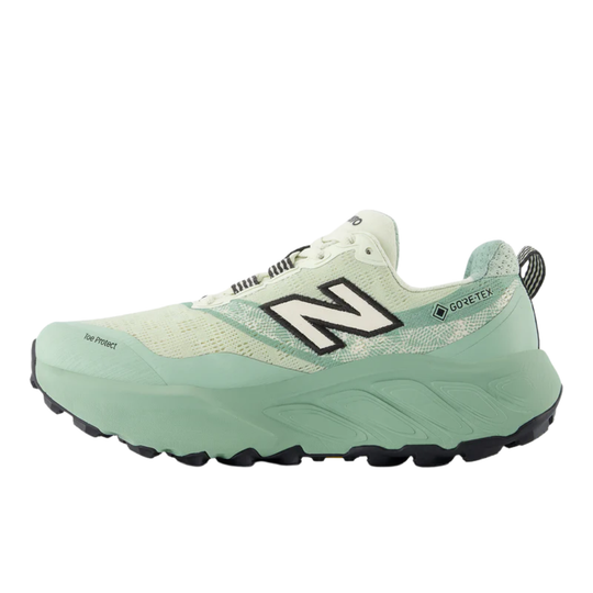Green running shoe with New Balance logo on a white background