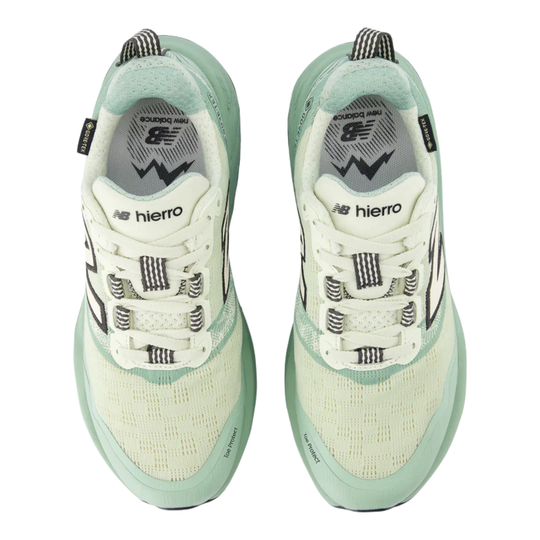 Pair of light green and white sneakers with 'hierro' branding on a white background
