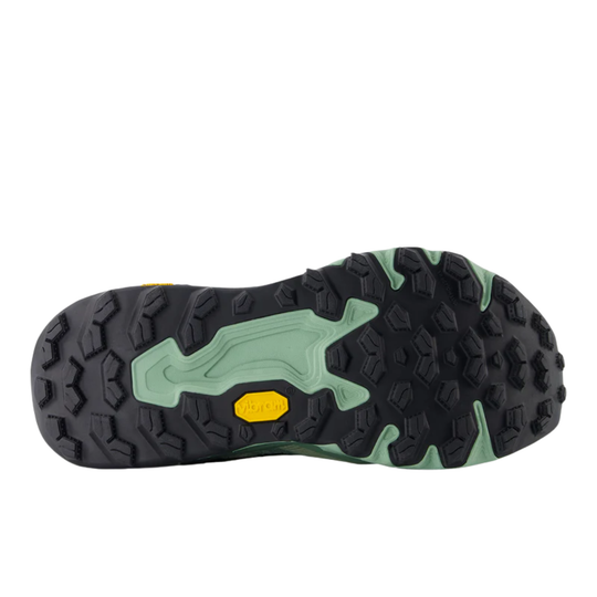 Close-up of a shoe sole with green and black pattern on a white background