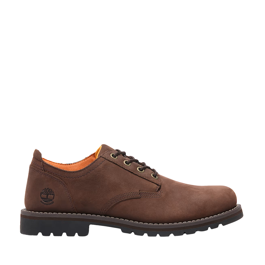 Brown leather shoe with orange lining on a white background