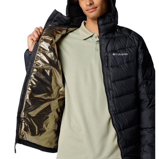 Person wearing a black puffer jacket with reflective lining, featuring the Columbia brand.
