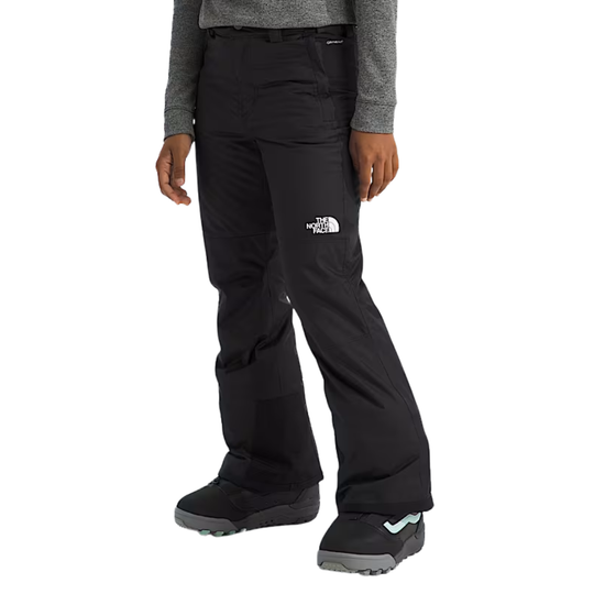 Person wearing black snow pants with The North Face logo on a white background