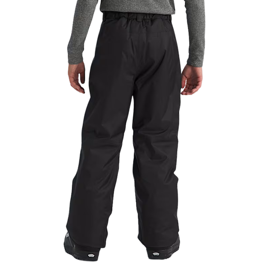 Black snow pants worn by a person on a white background