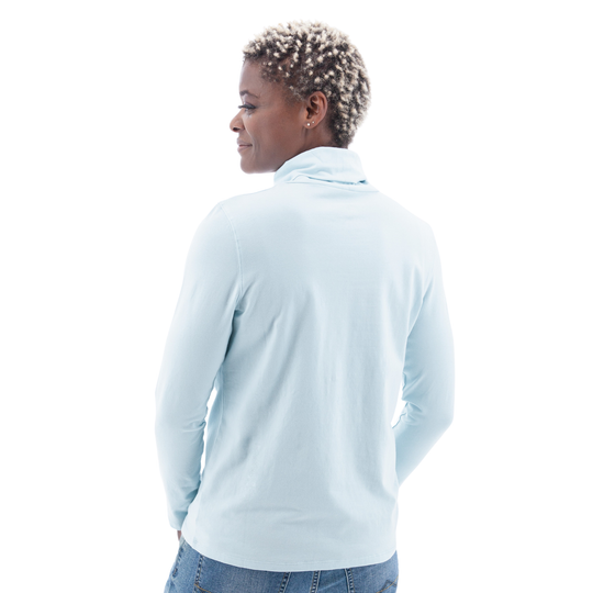 Person wearing a light blue long-sleeve shirt on a white background