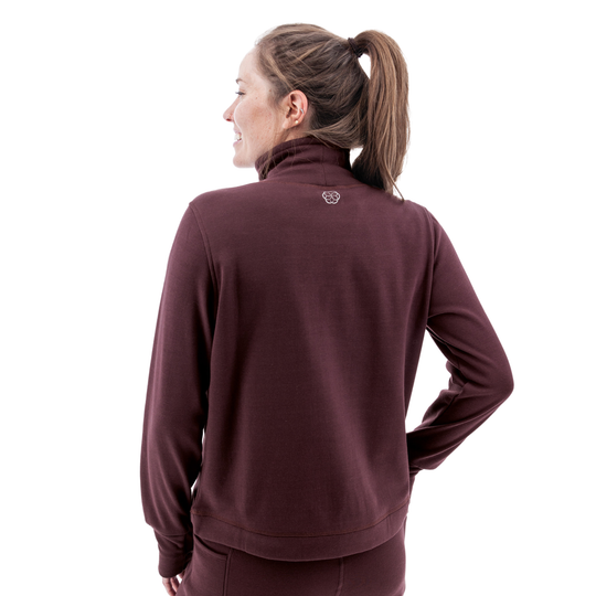 Woman wearing a maroon jacket on a white background