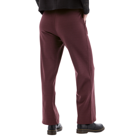 Maroon wide-leg fleece pants shown from the back with black shoes