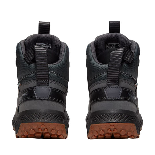 Black hiking boots with brown soles on a white background