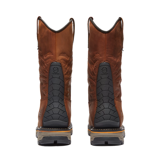 Pair of brown leather boots with black soles on a white background