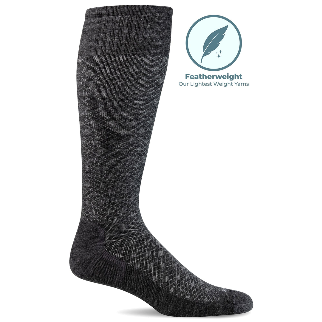 Gray knee-high sock on a white background with a featherweight yarn label.