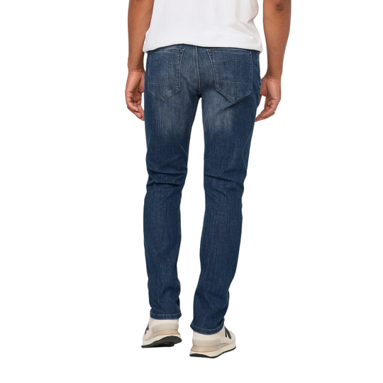Person wearing blue jeans on a white background