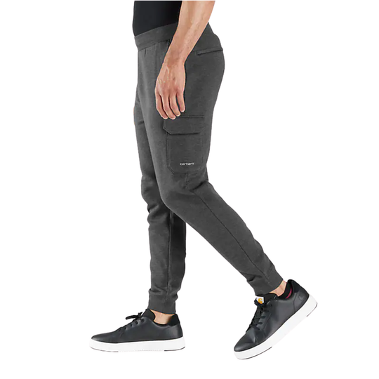 Person wearing dark gray cargo jogger pants on a white background