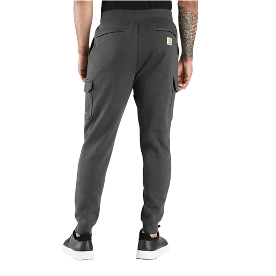Person wearing gray cargo jogger pants on a white background