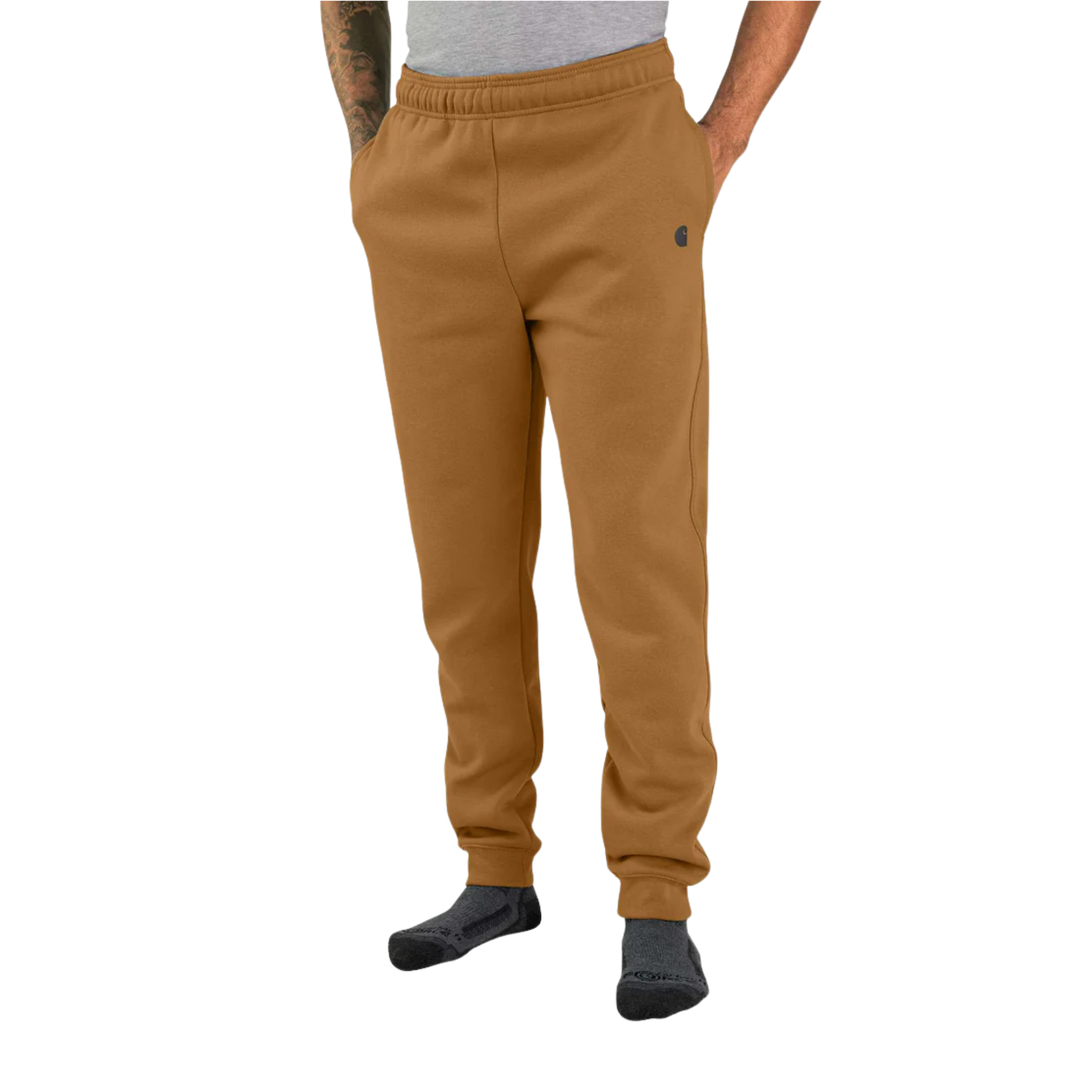 Brown sweatpants worn by a person on a white background