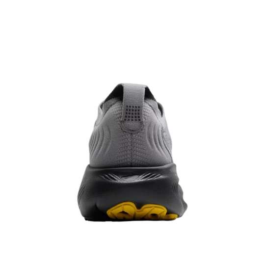 Gray athletic shoe with yellow sole on a white background