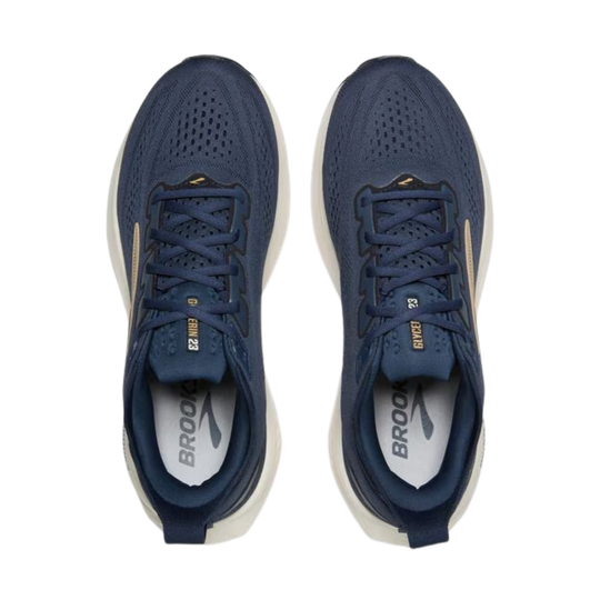 Pair of blue running shoes with white soles on a white background
