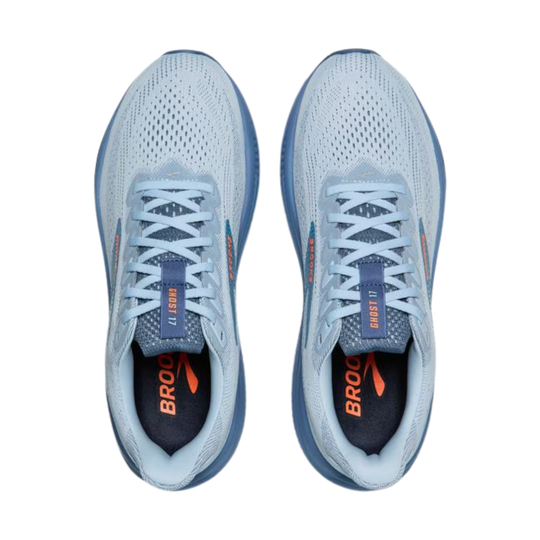 Pair of light blue running shoes with orange accents on a white background