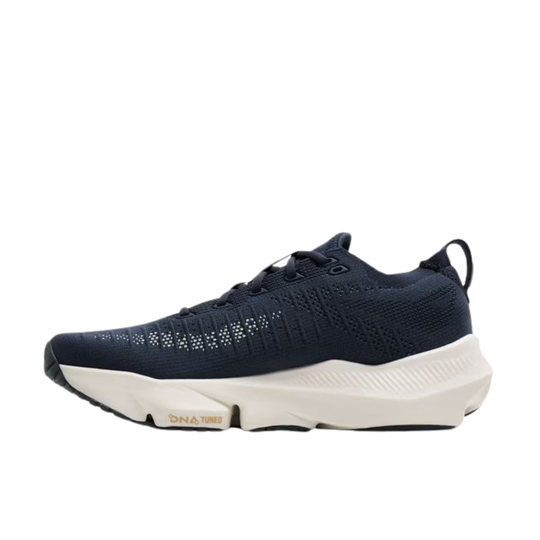 Navy running shoe with white sole on a white background