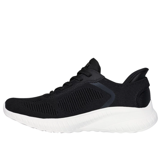 Black slip-on athletic shoe with a white thick sole, knit upper, and side stripe detail