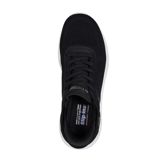 Black knit slip-on sneaker with elastic laces and a white sole, top view