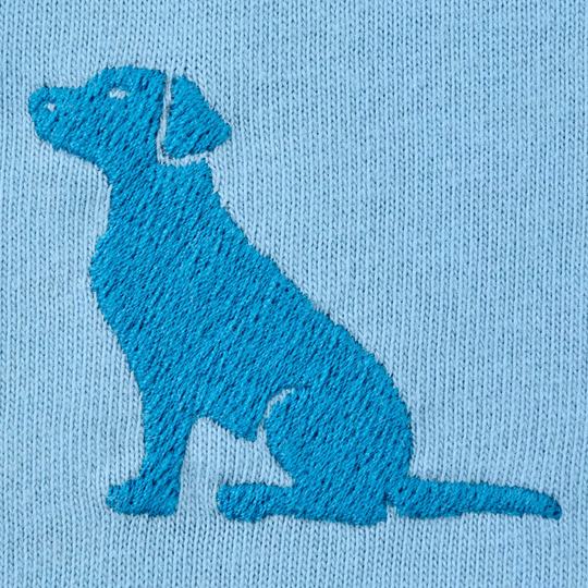 Embroidered silhouette of a dog on a blue fabric background