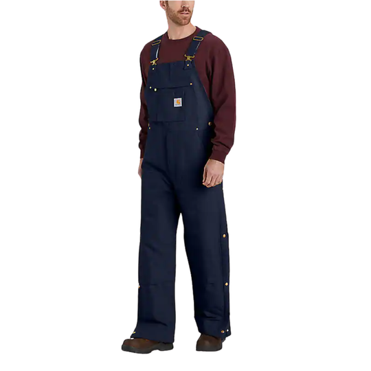 Man wearing navy blue bib overalls on a white background