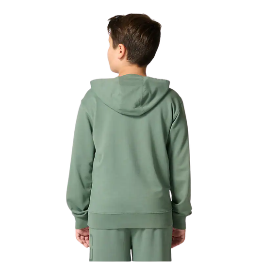 Person wearing a green hoodie and pants on a white background