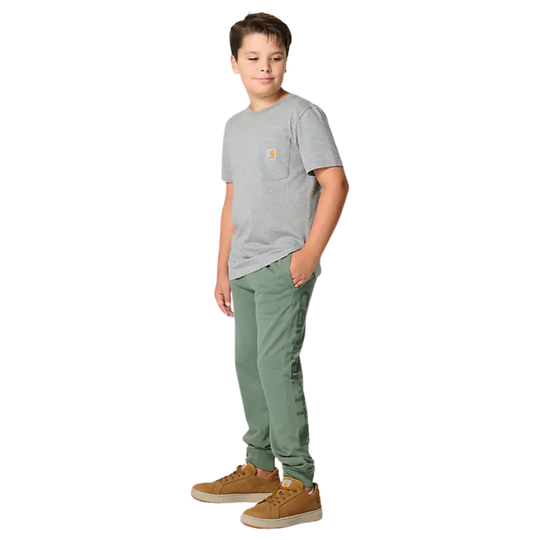 Child wearing a gray t-shirt and green pants on a white background