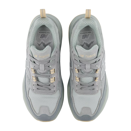 Pair of gray sneakers with gold accents on a white background