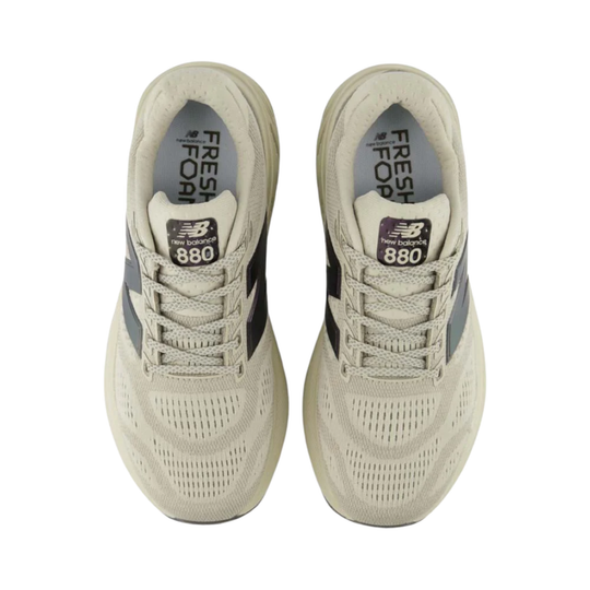 Pair of beige sneakers with 'Fresh Foam' and 'New Balance 880' text on a white background