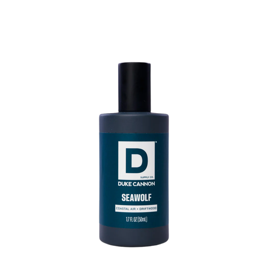 Dark blue cologne bottle with black cap on a white background