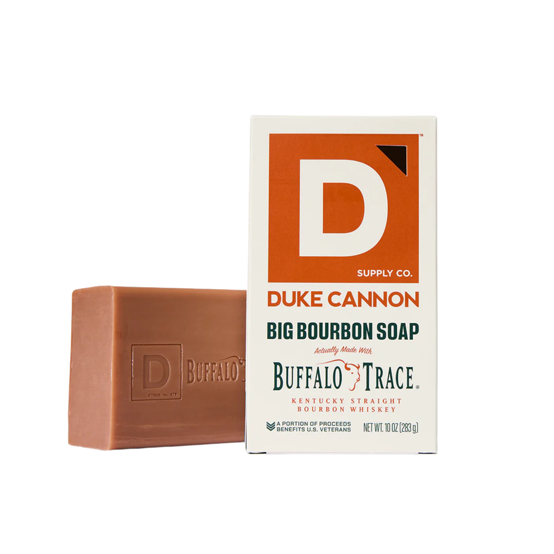 Brown soap bar beside its box with a large D logo and bourbon branding