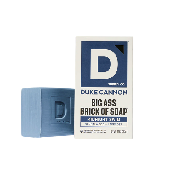 Blue bar of soap and its packaging with 'Duke Cannon' branding on a white background.