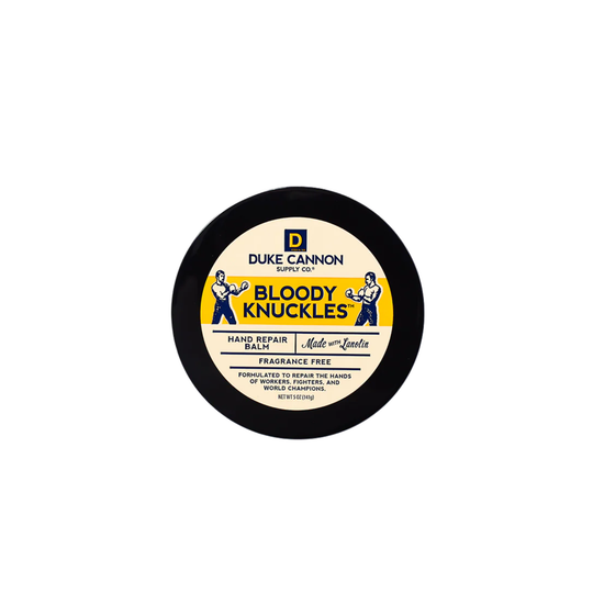 Round black tin of hand repair balm on a white background