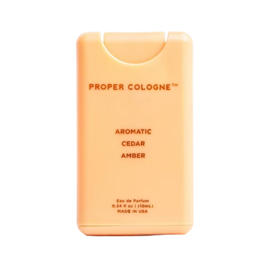 Orange cologne bottle labeled 'Proper Colonge' on a white background