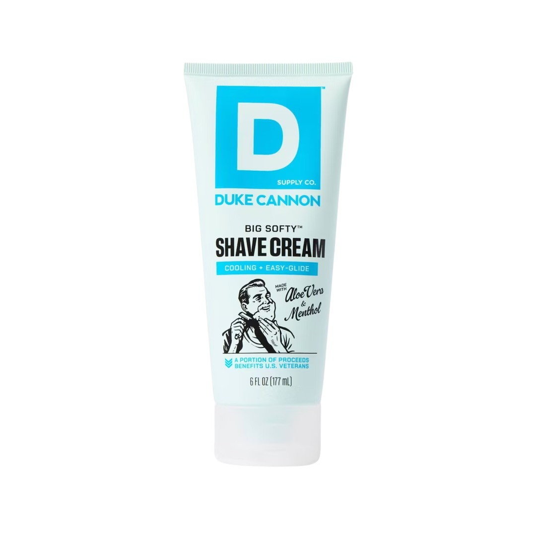 White and light blue tube of shave cream with a large D logo and black illustration near the bottom.