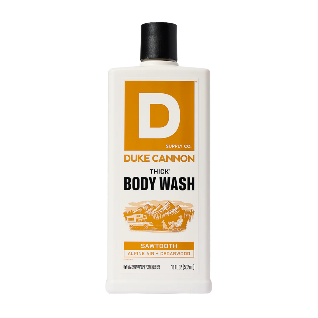 White body wash bottle with black cap and orange label reading "D" and "BODY WASH"