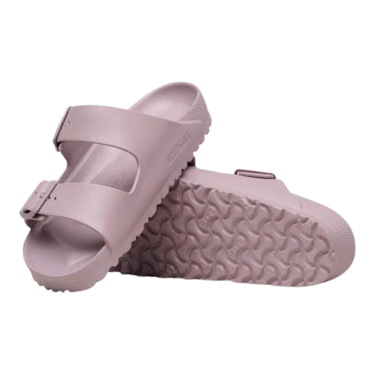 Pair of light purple sandals with textured sole on a white background